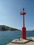 Red lighthouse in a little Croatian harbor