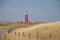 Red lighthouse, little houses on Texel