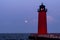 Red Lighthouse in Milwaukee with rising full moon