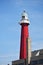 The red lighthouse at Scheveningen Beach .