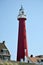 The red lighthouse at Scheveningen Beach .