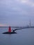 Red Lighthouse and Smoke Stacks in Dublin Harbor