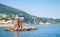 Red lighthouse tower on stone breakwater, Italy