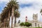 Red lighthouse, white German fort and row of palms, of colonial town of Swakopmund