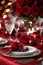 Red linens, elegant dinnerware, and romantic candlelight