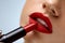 Red Lips. Closeup Of Woman Beauty Face With Bright Lipstick On