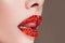 Red lips covered with rhinestones. Beautiful woman with red lipstick on her lips.