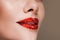 Red lips covered with rhinestones. Beautiful woman with red lipstick on her lips.