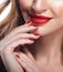 Red Lips and Nails closeup. Blond hair. Manicure and Makeup