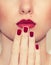Red Lips and Nails closeup. Closed Mouth. Manicure and Makeup.
