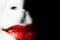 Red lips of a young woman on black background