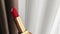 Red lipstick in golden tube as luxury cosmetic product, make-up and beauty