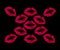 Red lipstick kisses on a black background