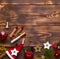 Red lipstick and lip gloss and eyelids on a wooden background in the Christmas decor. Holiday makeup for the new year, gift, shopp