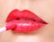 Red Lipstick. Lip Gloss on Lips and Brush.