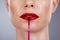 Red lipstick, lips and woman isolated on a studio background for makeup or product promotion. Model face with mouth