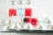 Red liquid in disposable syringe on blister pack on medicine via