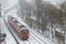 Red local train in a snowfall in the Schweinfurt city