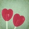 Red lollipop hearts on vintage background