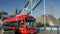 Red London Bus crosses Tower Bridge