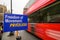 Red London bus with motion blur as it passes anti-Brexit Freedom of Movement sign