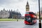 The red London bus at Westminster and the most famous London landmark Big Ben