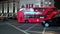 Red London Double Decker buses pass Police Officers and protesters at a Polish pro choice protest at Oxford Circus at night