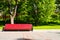 Red long chair in park. Outdoor and relax background.