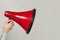 Red loudspeaker megaphone on white