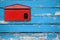 Red mailbox with blue wood