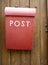 Red mailbox on a wooden door