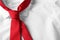 Red male necktie on white shirt, closeup