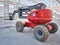 Red man lifting platform machinery at construction site