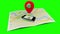 Red marker pointing at a mobile lying on a map of a town