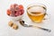 Red marmalade in bowl, sugar cubes, tea and teaspoon