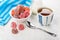 Red marmalade in bowl, sugar, tea, blue napkin and teaspoon