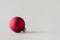 Red matte Christmas ball on a seamless grey background