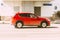 Red Mazda CX-5 on the city street. Fast moving SUV on urban road with blurred background