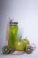 Red measuring tape over green sport bottle, apple and kiwi. Diet and Healthy life, sport concept. Copy space. Isolated