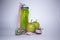 Red measuring tape over green sport bottle, apple and kiwi. Diet and Healthy life, sport concept. Copy space. Isolated