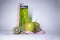 Red measuring tape over green sport bottle, apple and kiwi. Diet and Healthy life, sport concept. Copy space. Isolated