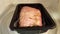 Red meat pork in plastic bag in container in microwave