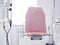 Red medical chair coach among various medical equipment for diagnosing diseases and health in white interior of doctors office