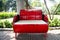 Red metal bench decoration and furniture in public garden park made from gas oil iron tank