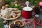 Red metal cocoa mug with marshmallows and glazed cookies. Christmas and New year