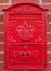 Red Metal Mailbox on brick wall