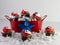 Red metal oblong bucket filled with white paper shreds and mini chocolate cupcakes with red and white frosting and star sprinkles