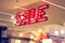 Red metal signage shop lighting on shopping mall background