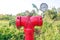 Red metallic fire hydrant with pressure gauge