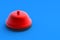 Red metallic service bell on blue background. Administrator call. Copy space